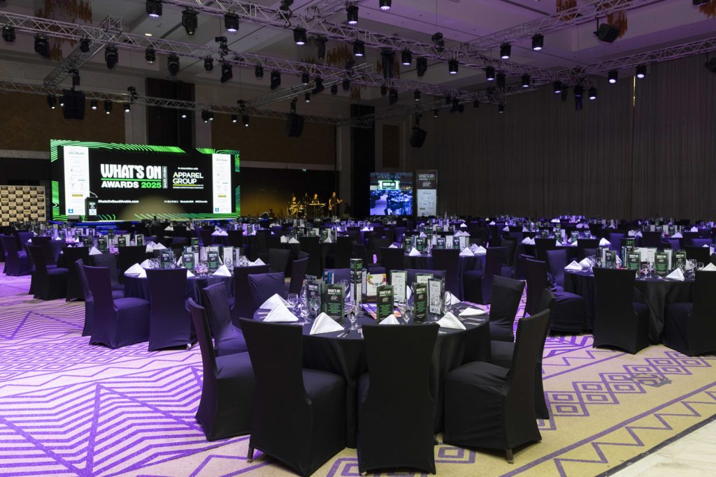 Technical production crew preparing a Jeddah hotel ballroom for a corporate gala dinner