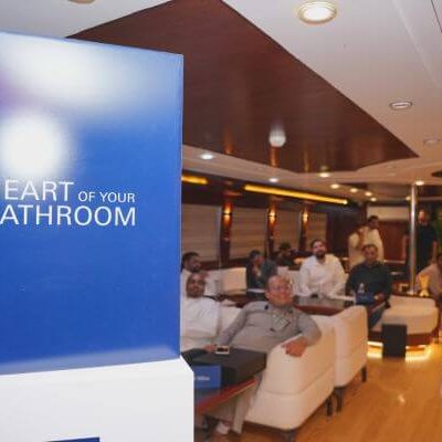 GROHE branded cubes and flags with guests playing FIFA tournament onboard