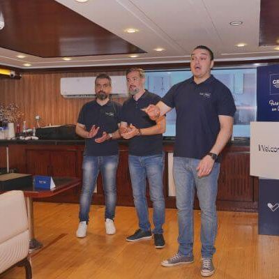GROHE branded cubes and flags with guests playing FIFA tournament onboard