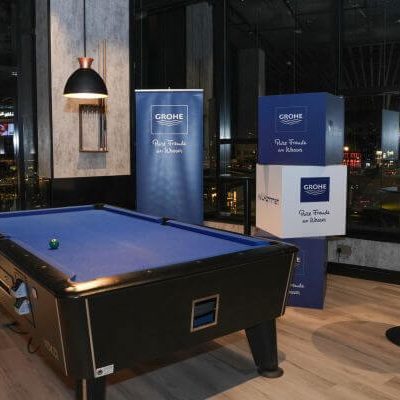 Custom coated paper reams and branded stands placed along bowling lanes
