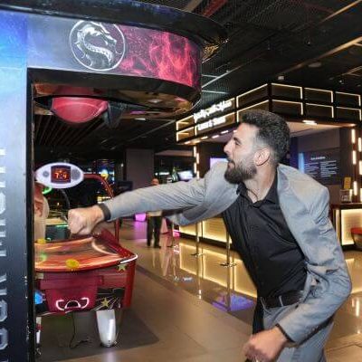 Guests enjoying arcade games and networking at private GROHE event in Esplanade