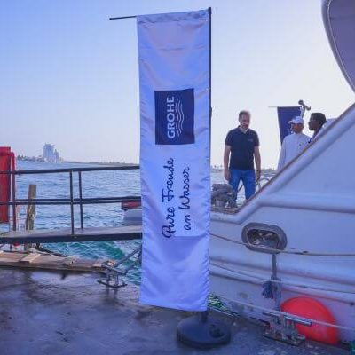 Professional videographer capturing GROHE client interactions onboard